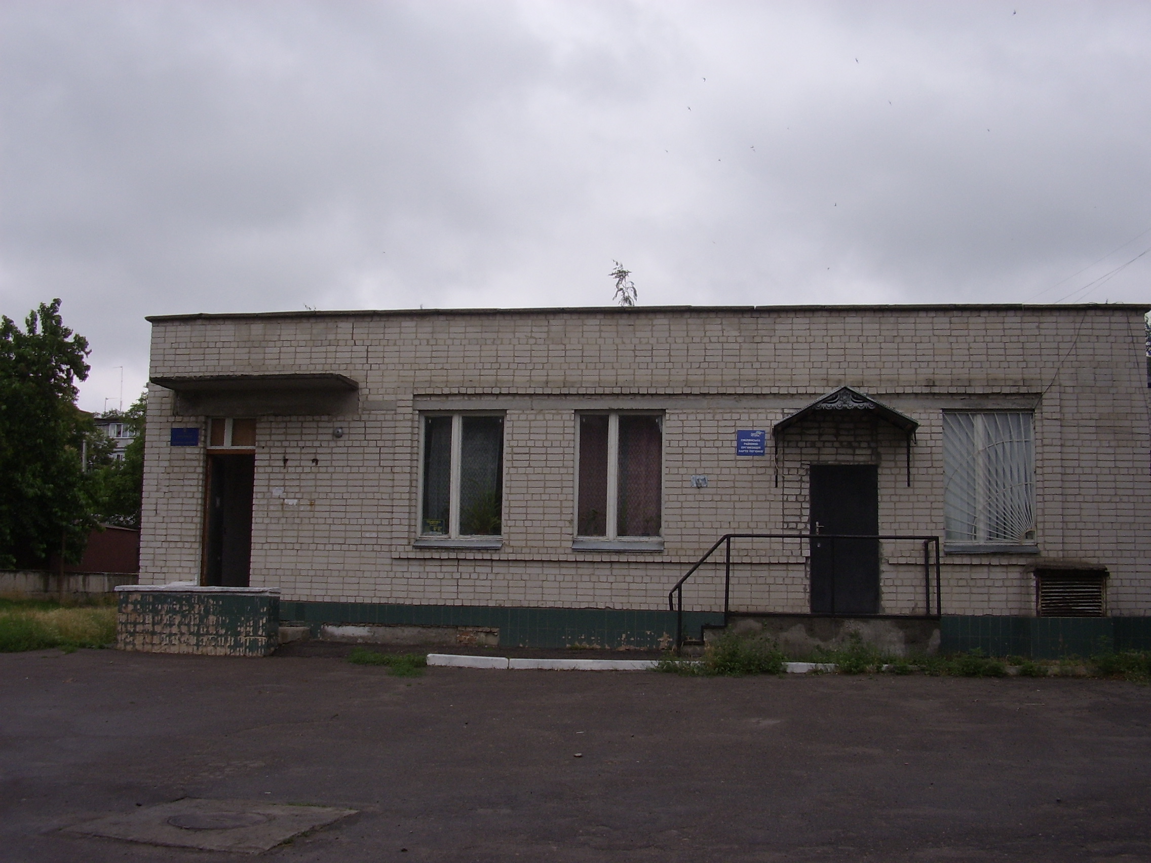 Зовнішній вигляд бібліотеки. Вхід - ліворуч. Зараз двері відкриті цілий день. Бібліотекарі намагаються створити хоч якийсь протяг, щоб вигнати з приміщення вологу